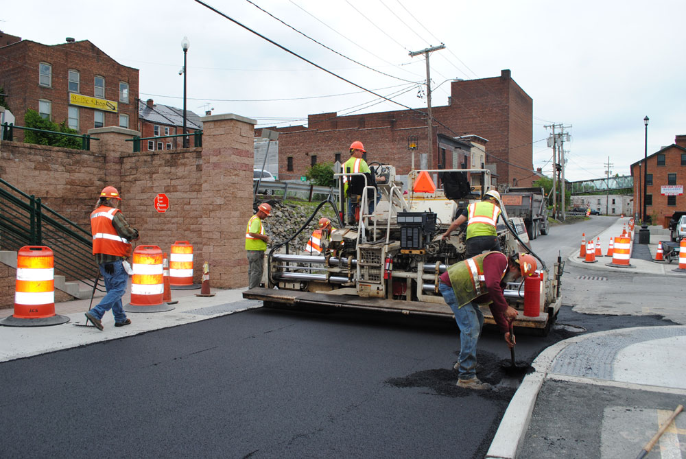A. Colarusso employees at work on road adding blacktop